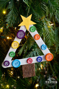 DIY Kids Christmas Tree Ornament You are going to LOVE creating these DIY Kids Christmas Tree Ornaments! This is a quick and easy craft for you and your kids, you can make 7-10 trees in under an hour. Make your tree unique by using different paint colors and embellishments, the possibilities are endless. They cost pennies to make and will look darling on any Christmas tree!