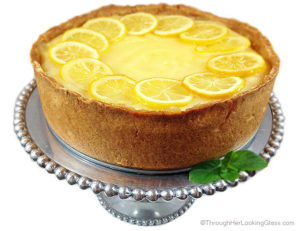 Spectacular Lemon Bar Cheesecake. Deliciously sweet and crunchy crust, creamy cheesecake and tangy homemade lemon curd. All garnished with tart candied lemon slices.